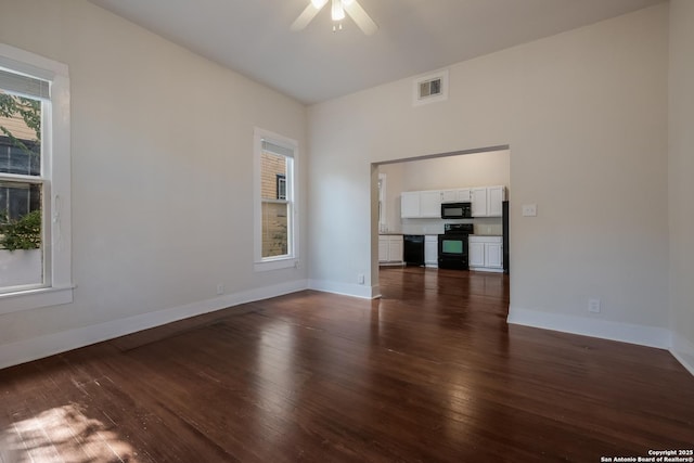 unfurnished living room with dark wood-type flooring and ceiling fan