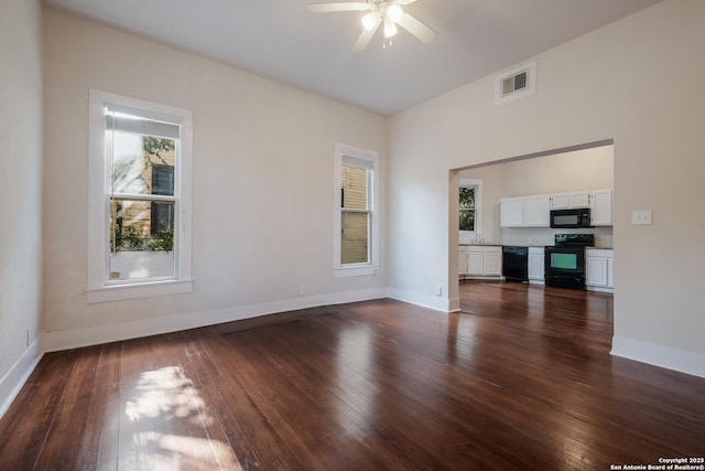 unfurnished living room with ceiling fan and dark hardwood / wood-style floors