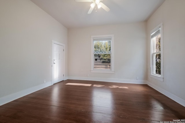 spare room with ceiling fan and dark hardwood / wood-style floors