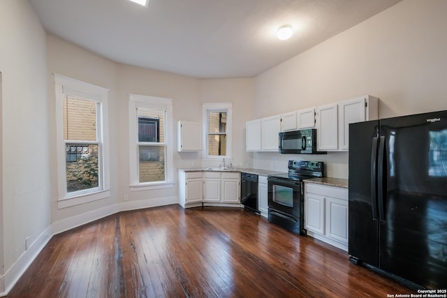 kitchen featuring sink, white cabinetry, black appliances, and dark hardwood / wood-style flooring