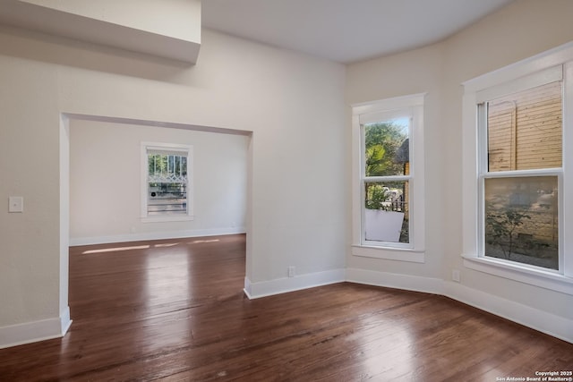 spare room with dark wood-type flooring