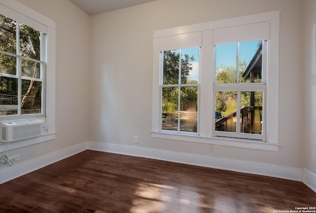 unfurnished room featuring dark wood-type flooring and cooling unit