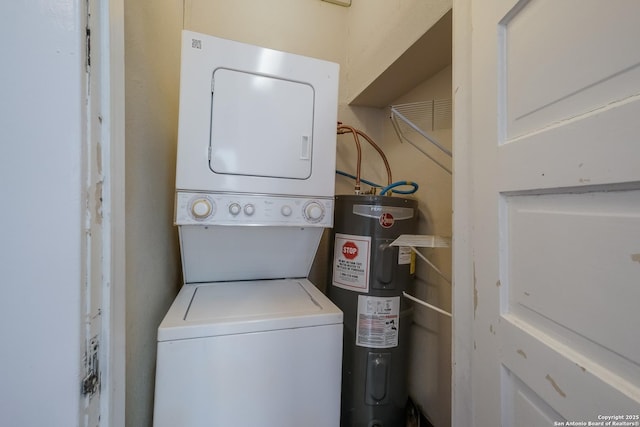 washroom with water heater and stacked washing maching and dryer