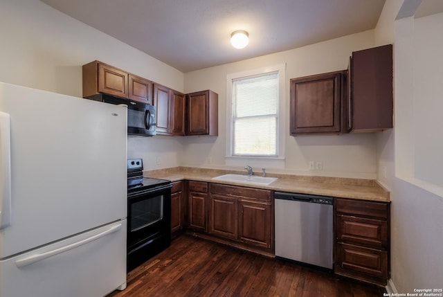 kitchen with black appliances, dark wood-type flooring, and sink