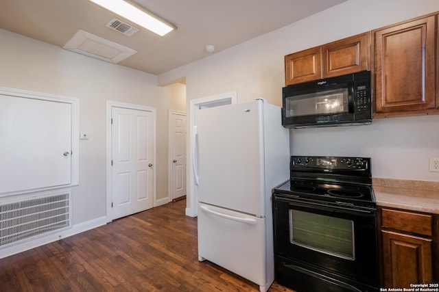 kitchen with dark wood-type flooring and black appliances