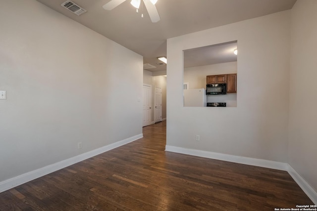 spare room with ceiling fan and dark hardwood / wood-style flooring