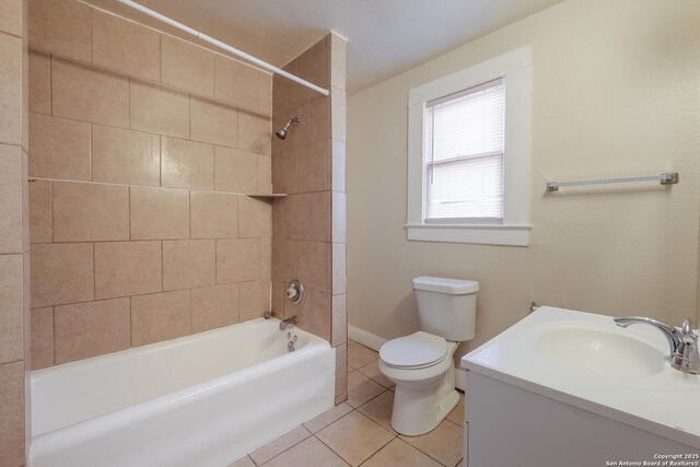 full bathroom with toilet, tiled shower / bath combo, tile patterned flooring, and vanity