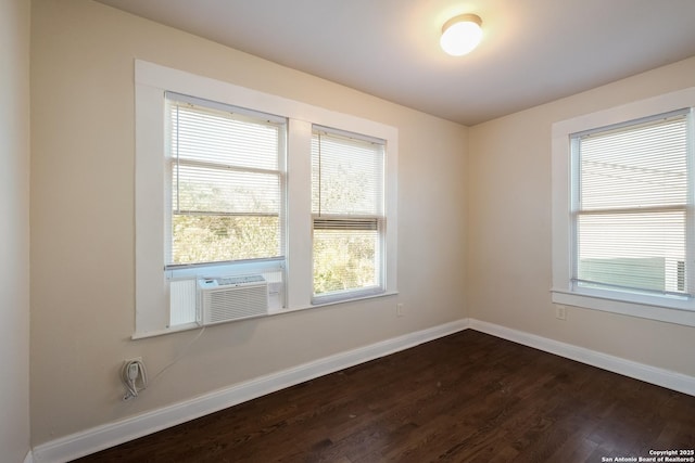 unfurnished room featuring cooling unit and dark hardwood / wood-style flooring