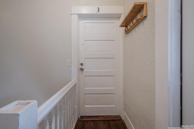 entryway with dark hardwood / wood-style flooring