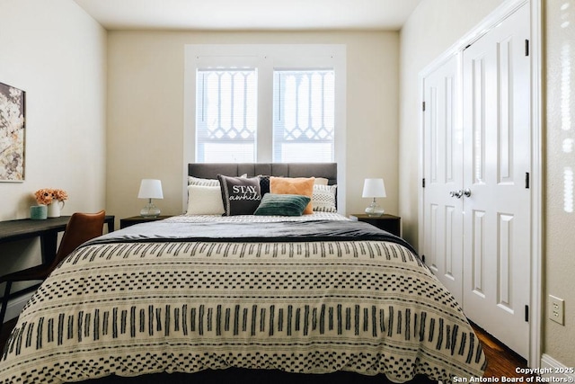 bedroom with wood-type flooring and a closet