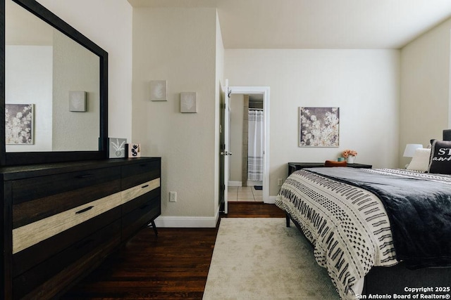 bedroom with dark hardwood / wood-style floors