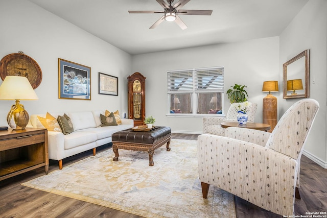 living room featuring ceiling fan and dark wood-type flooring