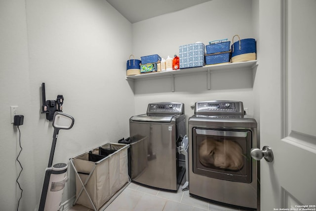 washroom featuring light tile patterned flooring and washer and dryer