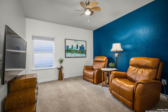 sitting room featuring ceiling fan and carpet