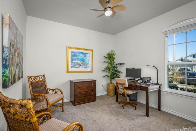 carpeted office space with ceiling fan