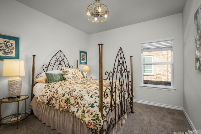 carpeted bedroom featuring an inviting chandelier