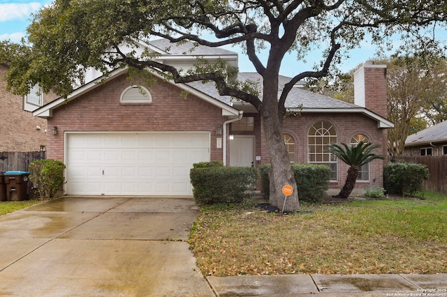 ranch-style house featuring a front yard and a garage