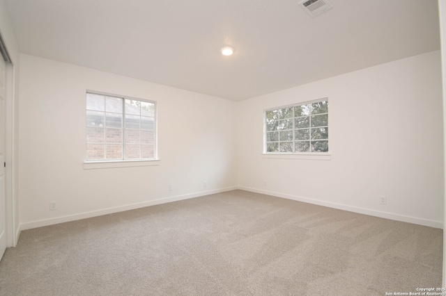 carpeted empty room featuring a healthy amount of sunlight