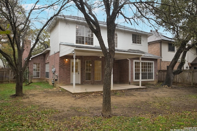 back of property with a patio