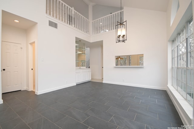 interior space featuring an inviting chandelier and a towering ceiling