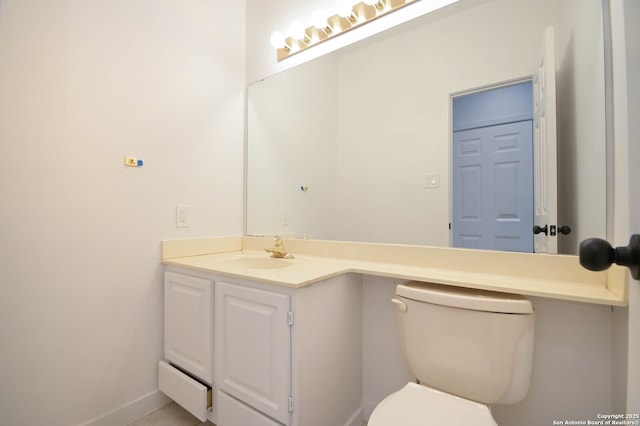 bathroom featuring toilet and vanity