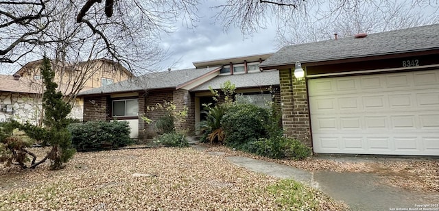 view of front of property featuring a garage and brick siding