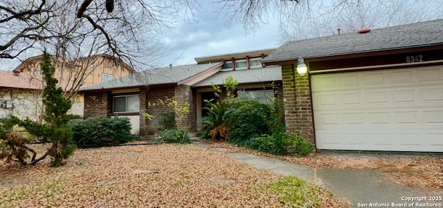 view of front of home featuring a garage and brick siding