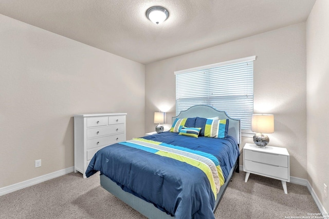 carpeted bedroom with a textured ceiling