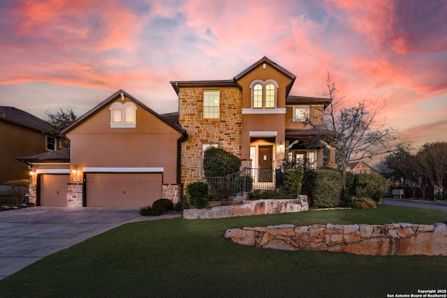 view of front property featuring a yard and a garage