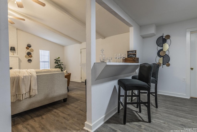 bar with ceiling fan, vaulted ceiling with beams, and dark hardwood / wood-style floors