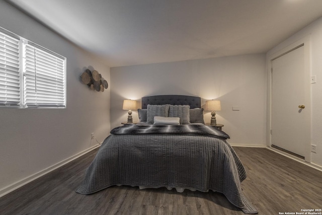 bedroom with dark hardwood / wood-style floors