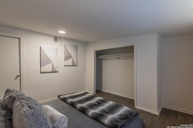 bedroom featuring dark wood-type flooring and a closet