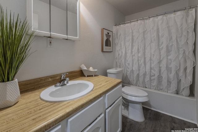 full bathroom with hardwood / wood-style flooring, toilet, vanity, and shower / bath combo