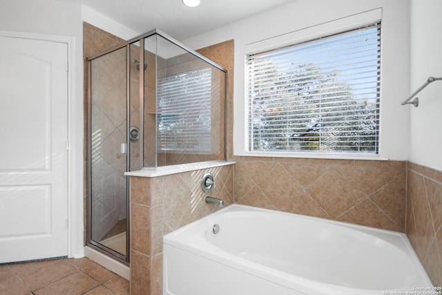 bathroom featuring independent shower and bath, tile patterned floors, and a wealth of natural light