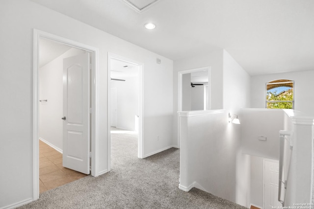 hallway featuring light colored carpet