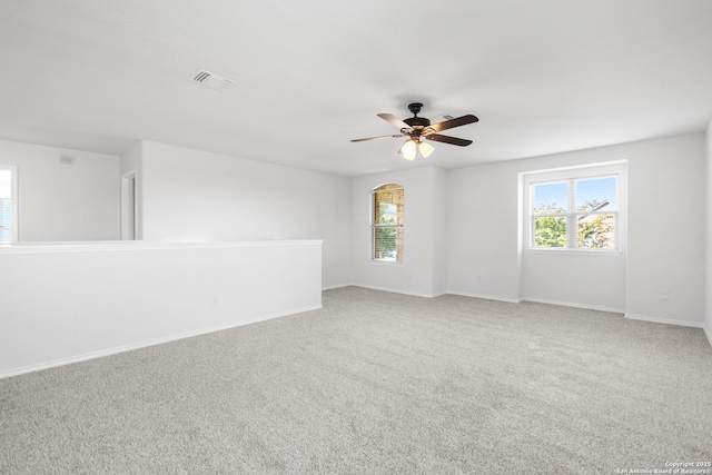 carpeted empty room featuring ceiling fan