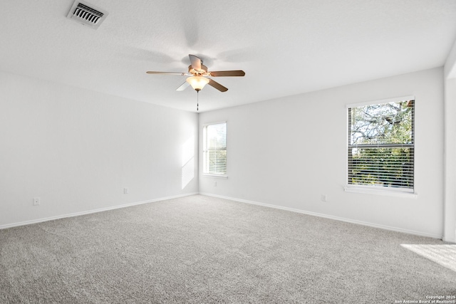 unfurnished room with ceiling fan and carpet flooring