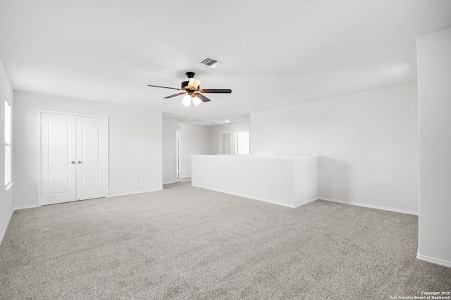 spare room with ceiling fan and carpet floors