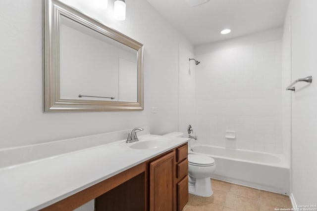 full bathroom featuring toilet, tiled shower / bath, and vanity