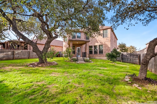 rear view of house with a yard