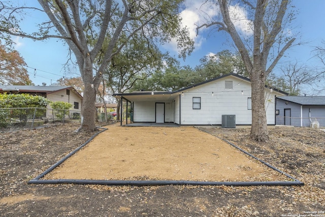 view of front of property with central AC and a carport