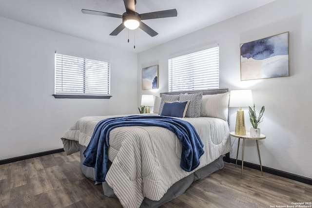 bedroom with dark wood-type flooring and ceiling fan