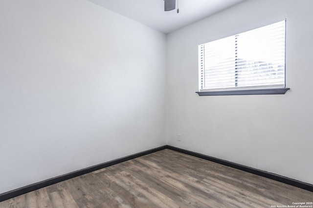 unfurnished room with dark hardwood / wood-style flooring