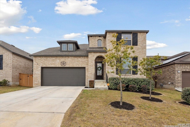 view of front of home featuring a garage and a front lawn