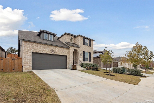 view of front of property with a front lawn and a garage