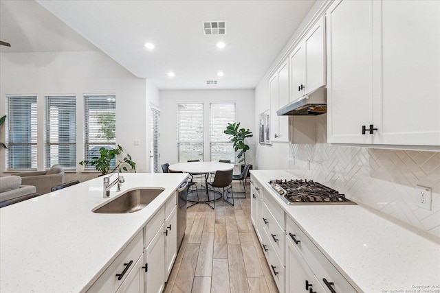 kitchen featuring white cabinetry, appliances with stainless steel finishes, backsplash, and sink