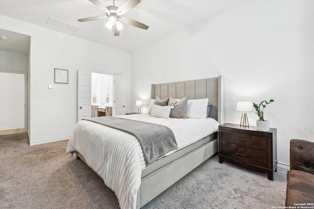 bedroom featuring connected bathroom, ceiling fan, and light colored carpet