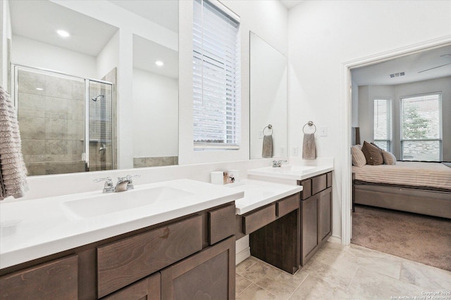 bathroom with walk in shower and vanity