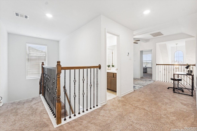 corridor featuring light colored carpet