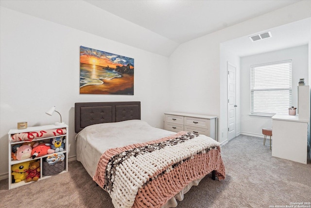 carpeted bedroom with vaulted ceiling